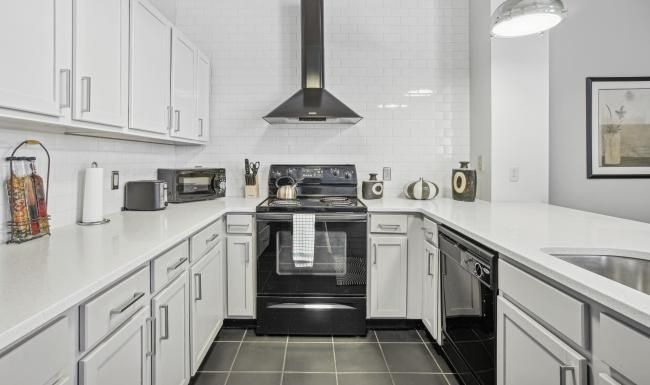 a kitchen with white cabinets