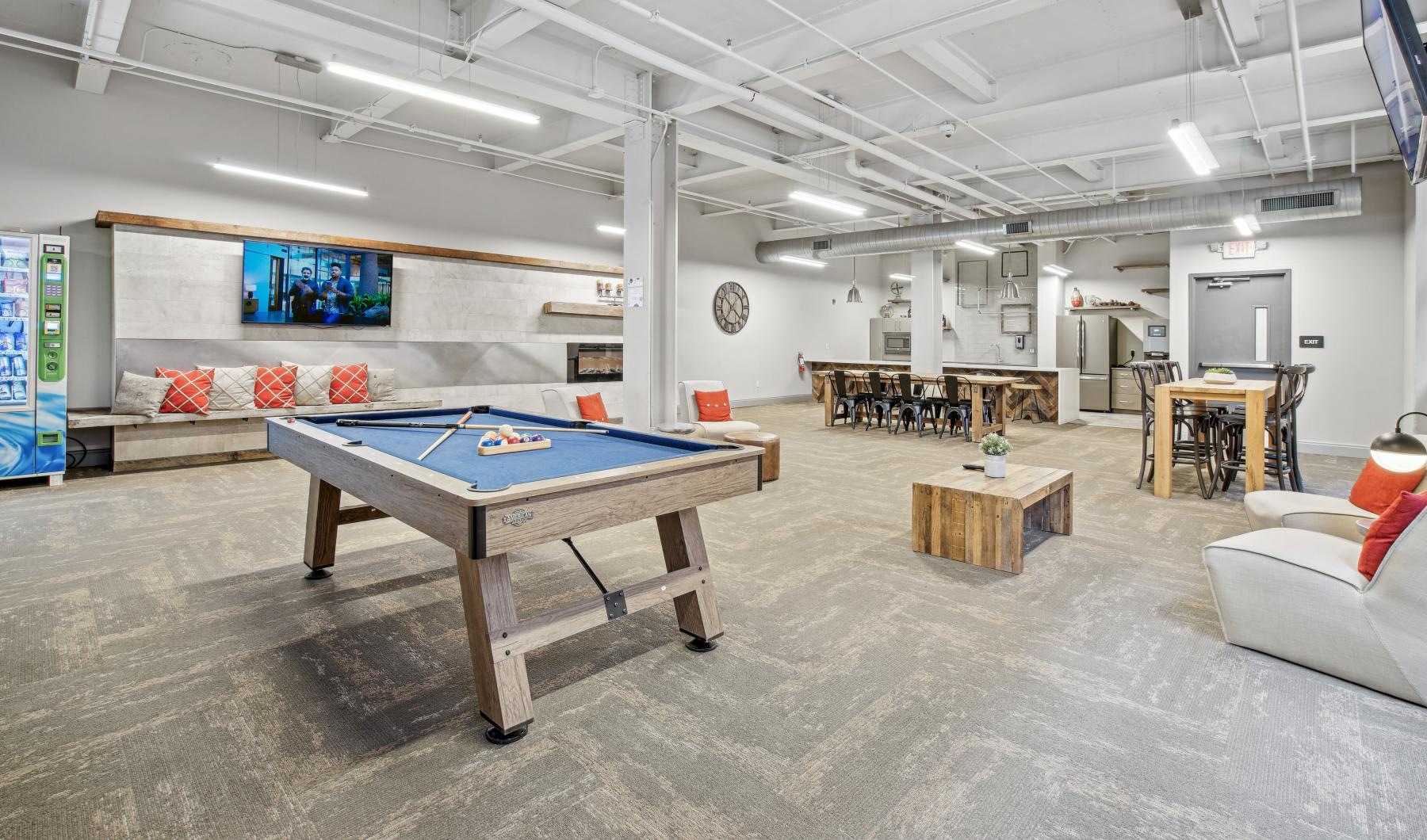 Enjoy our resident-only features a room with a pool table and chairs