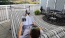 a person lying on a deck reading a book