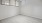 a room with a window and a white wall