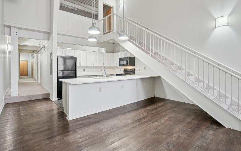 a kitchen with wooden-style flooring